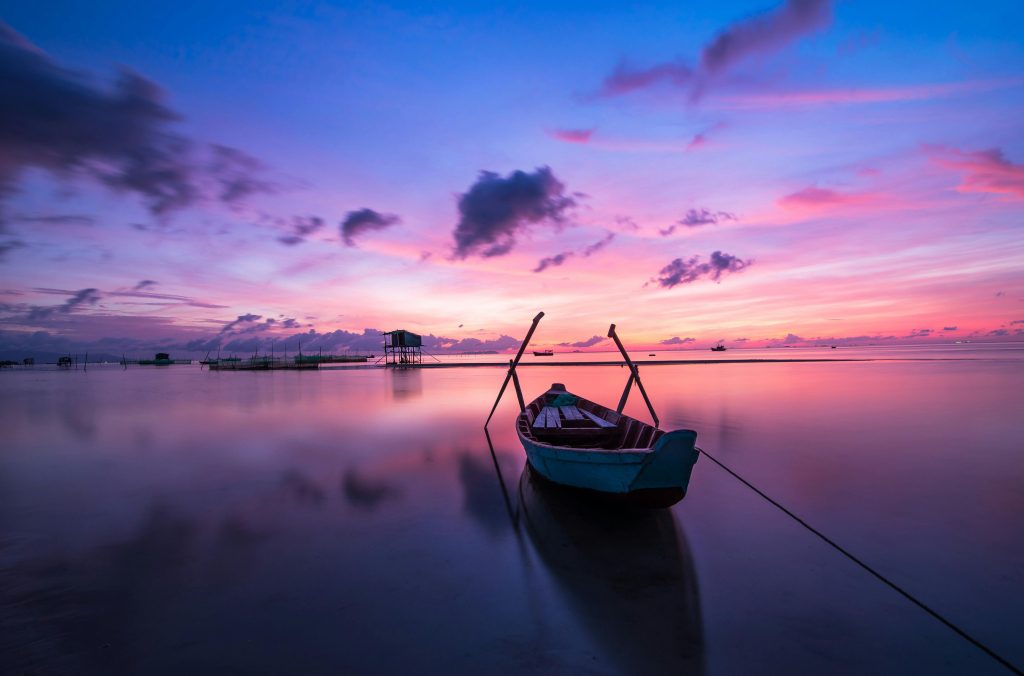 sunrise with a boat on the water